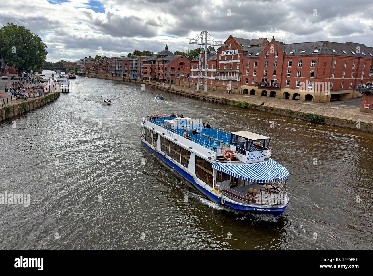 River Palace sightseeing boat on the River Ouse in York, carrying visitors on a city cruise past riverside buildings. Stock Photo
