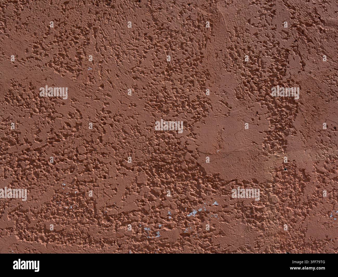 Old worn dark pink stucco or cement wall for use as a background texture Stock Photo