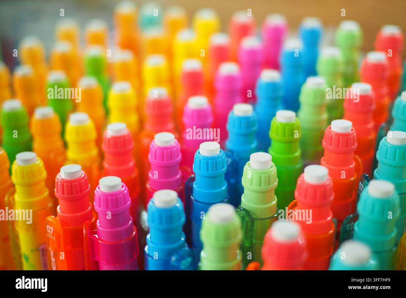 Colorful markers arranged neatly on a table Stock Photo