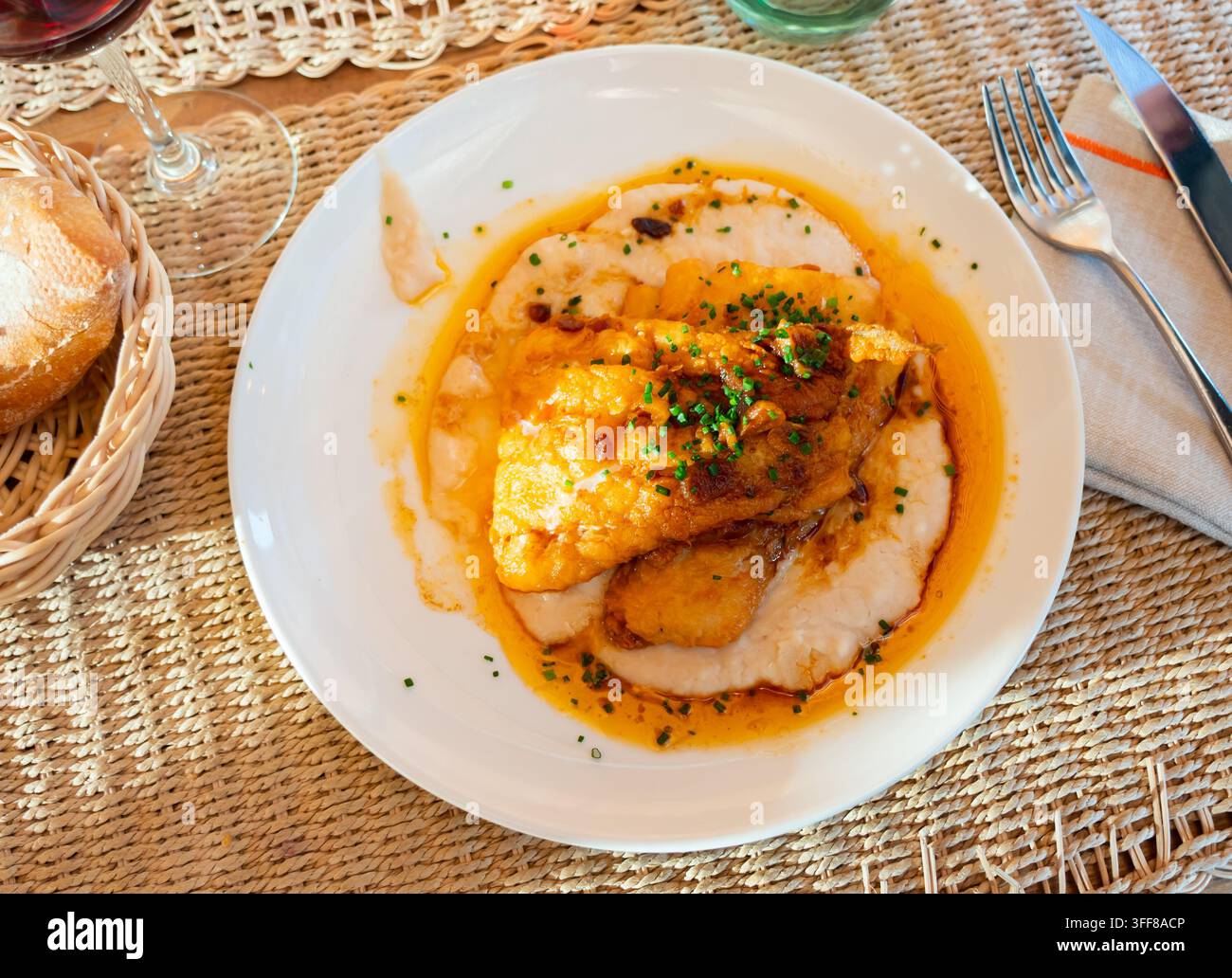 Delicious fried cod with creamy white beans and gravy Stock Photo
