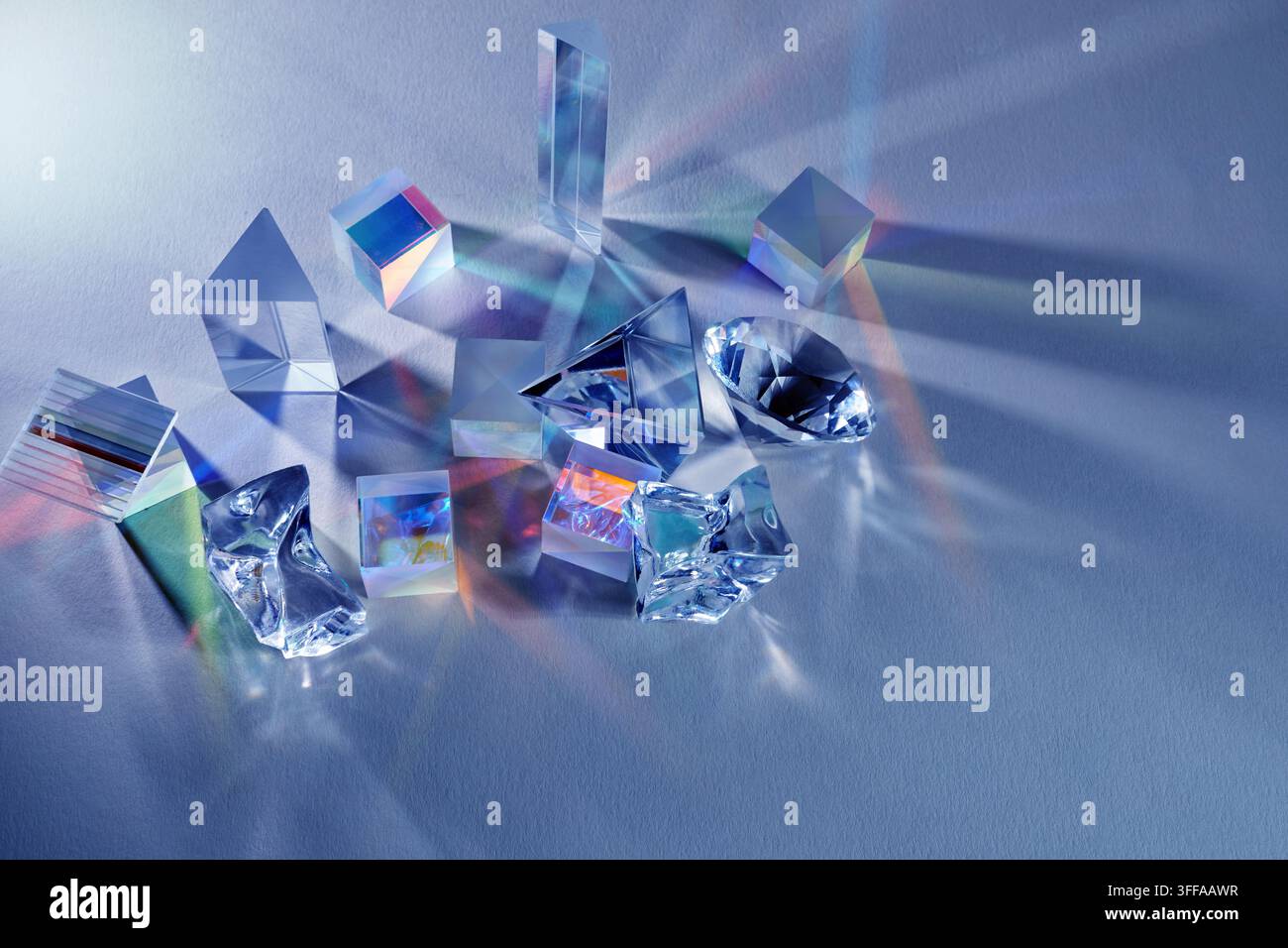 Glass prisms refracting light creating colorful spectrum Stock Photo