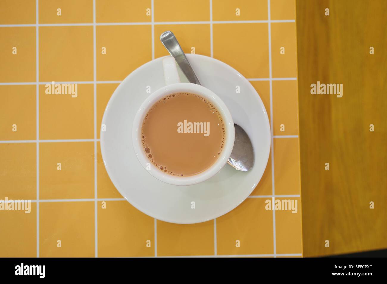 Cup of tea on a table with yellow grid pattern Stock Photo
