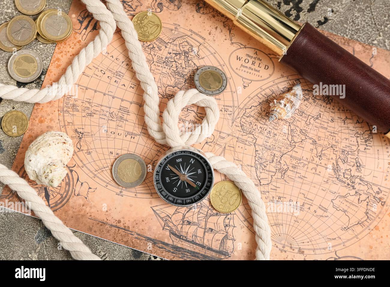 Compass, world map, seashells and rope on grey grunge background Stock Photo