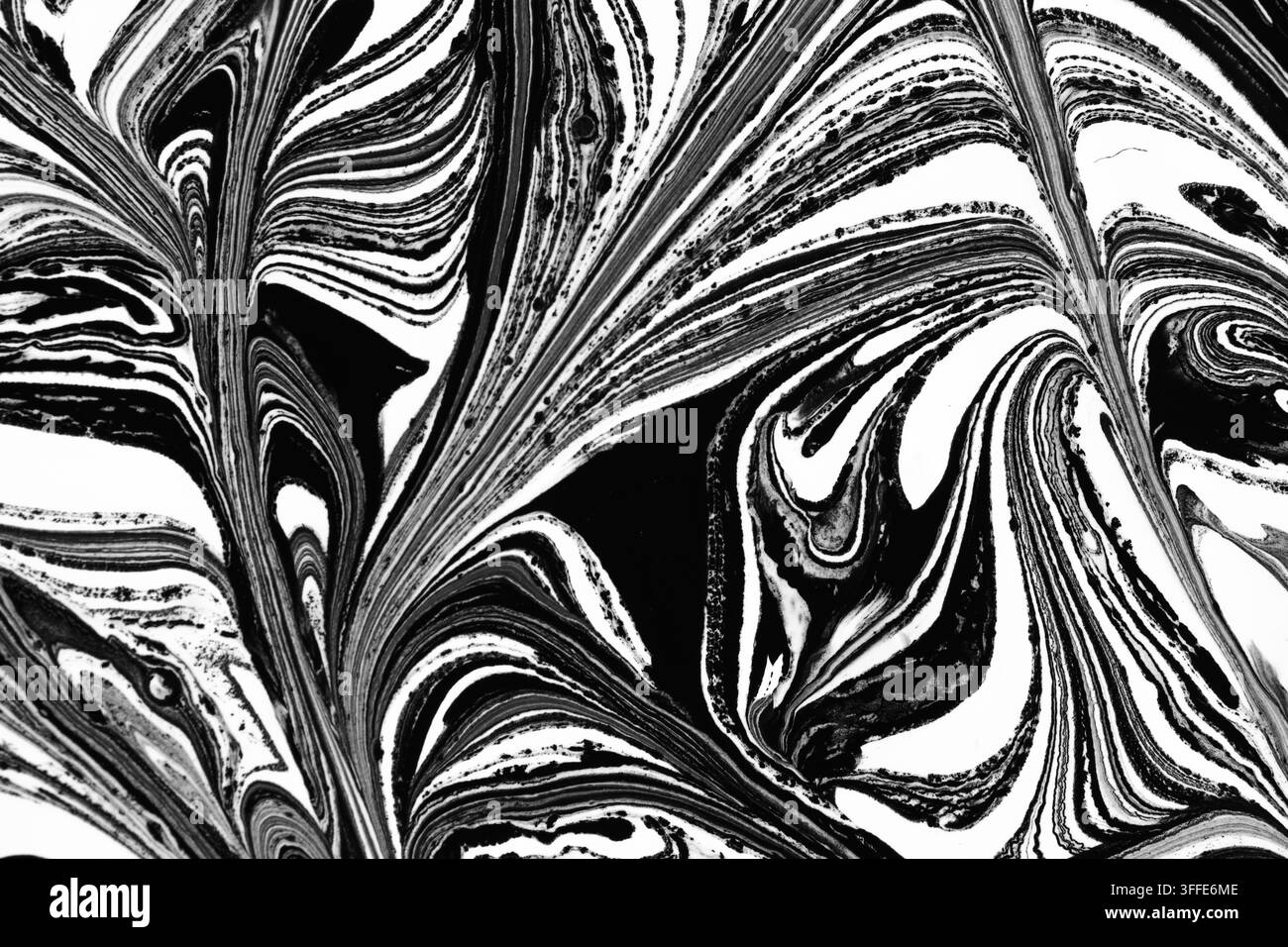Abstract black and white liquid marbling pattern featuring dynamic swoops and fluid paint textures Stock Photo