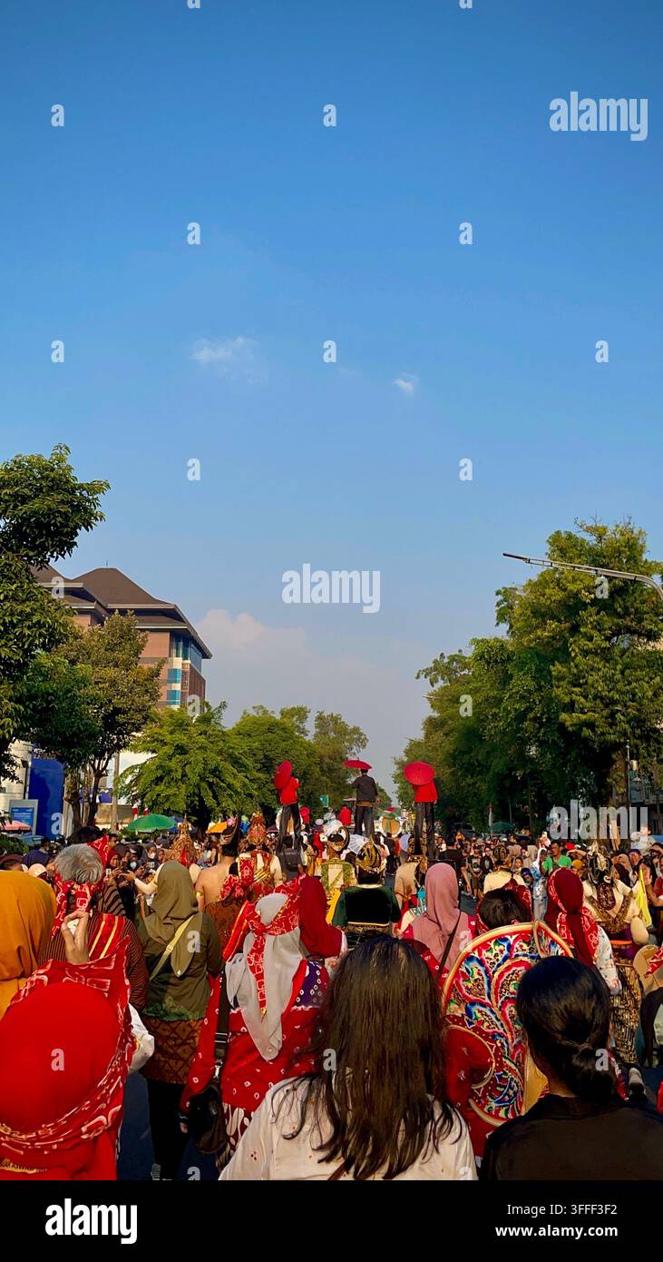 Participants and spectators during a development parade on Jalan Slamet Riyadi in Surakarta, Central Java, Indonesia. - Smartphone Captured Stock Image