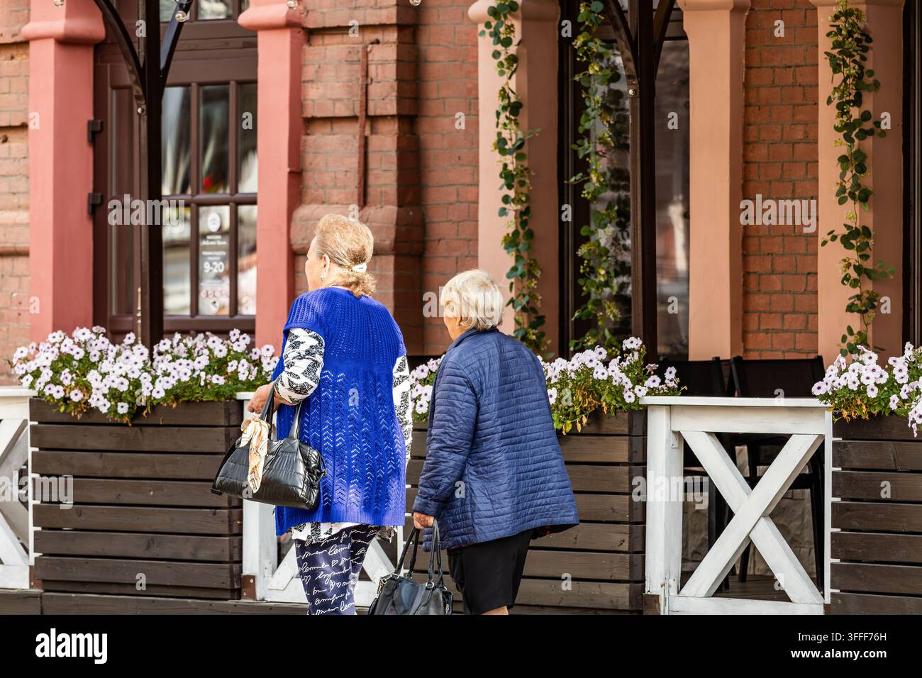 Pedestrians walk past floral hi-res stock photography and images - Alamy