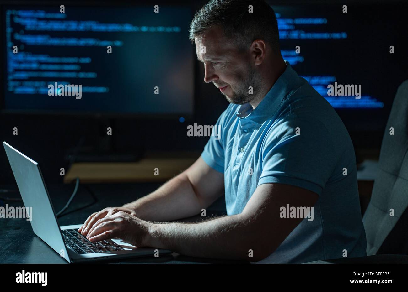 Network security specialist uses laptop. Network security specialist monitors cyber attack. Network security specialist analyzes code screen. Network Stock Photo