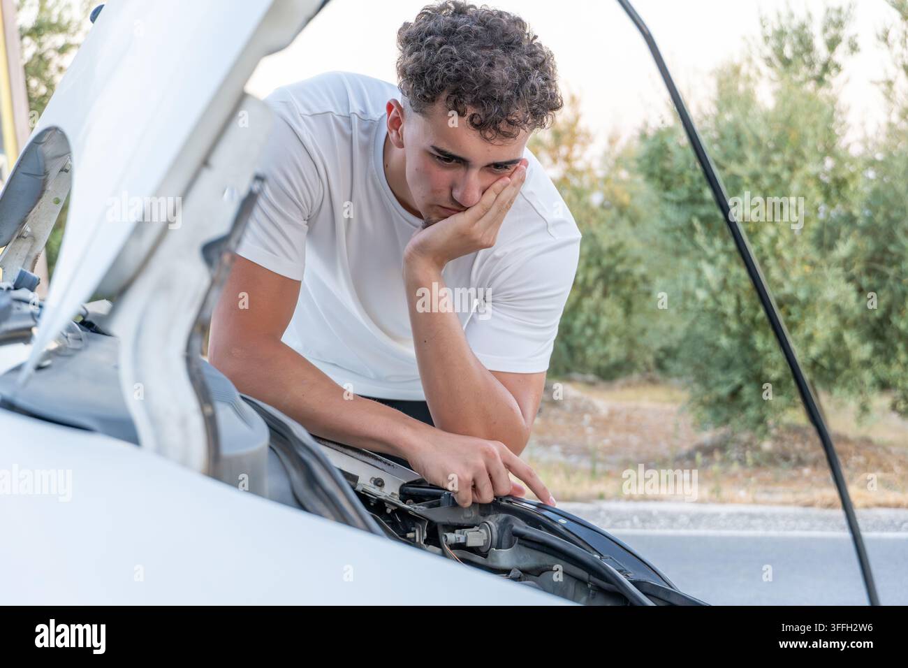 Young man frustrated by car breakdown problem Stock Photo