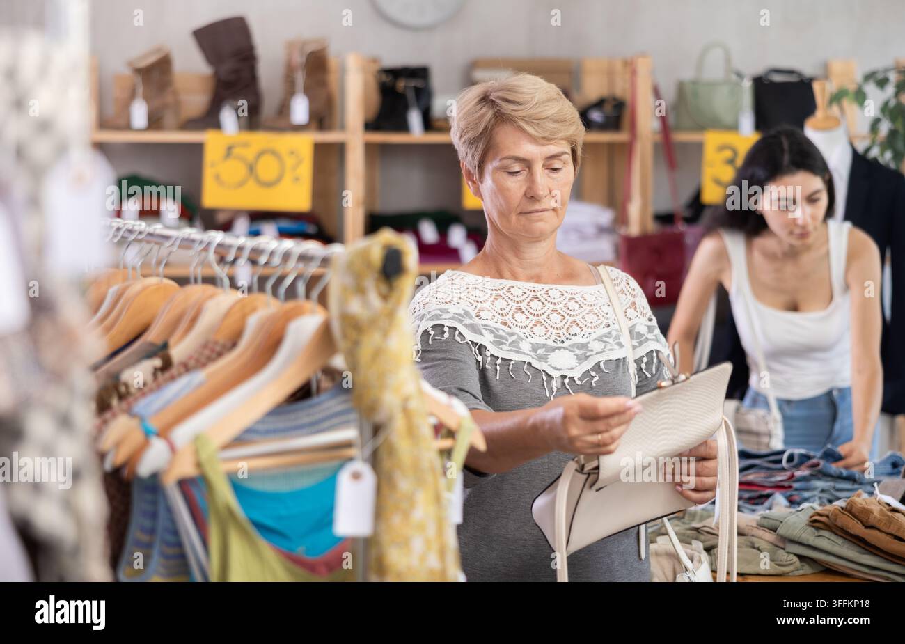 Woman Accessory Vector Mature woman stands in a store in the sale area of clothes and ...