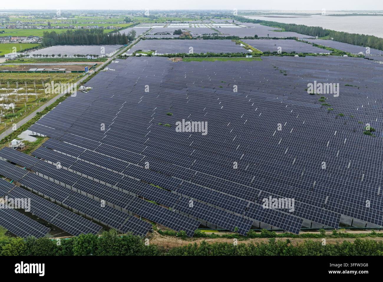 Contiguous Images YANGZHOU, CHINA - SEPTEMBER 9, 2026 - Photovoltaic panels are evenly ...