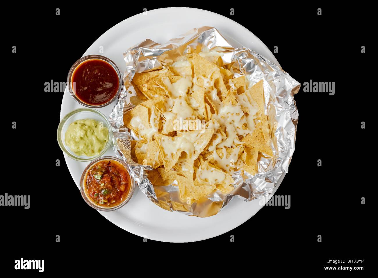 Nachos with melted cheese, guacamole, salsa, and dips Stock Photo