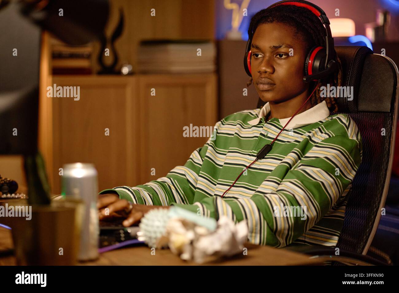 Black Man with Headset Playing Video Games at Computer Stock Photo