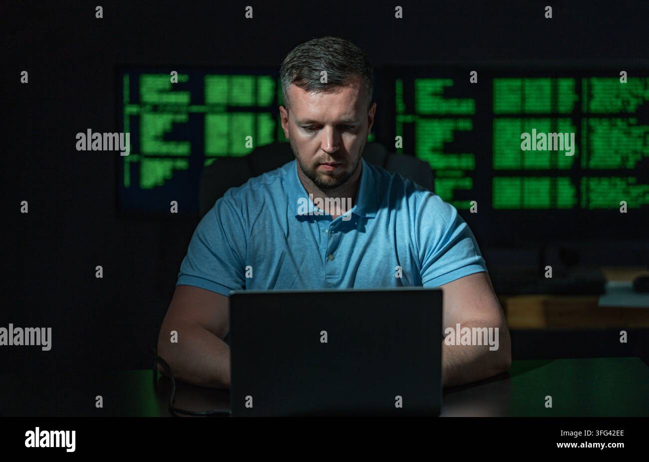 Programmer develops secure software system. Programmer writes programming on computer screen. Programmer monitors network and server logs. Programmer Stock Photo