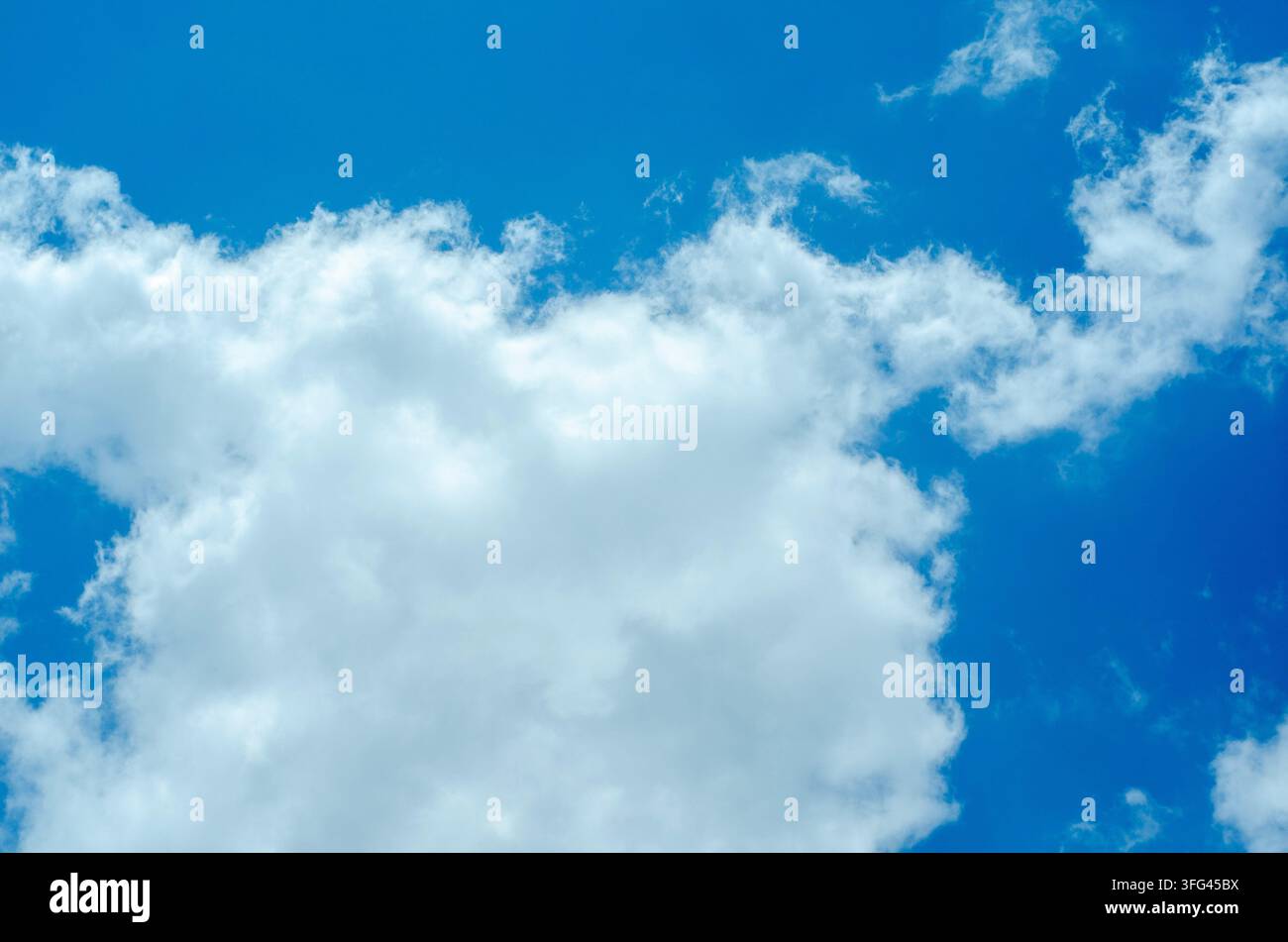 Soft White Clouds Floating in Deep Blue Atmosphere Stock Photo