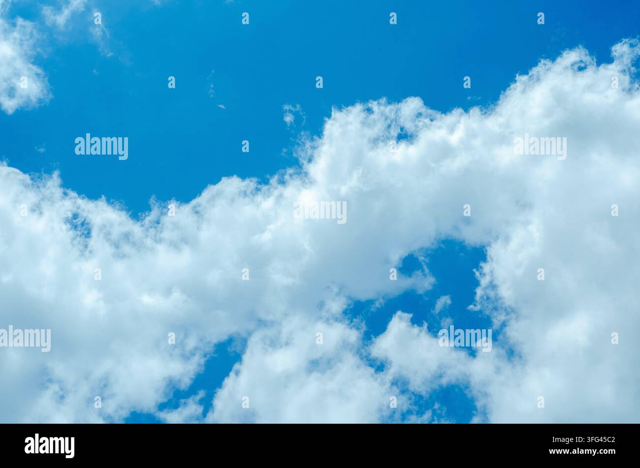 Soft White Clouds Floating in Deep Blue Atmosphere Stock Photo