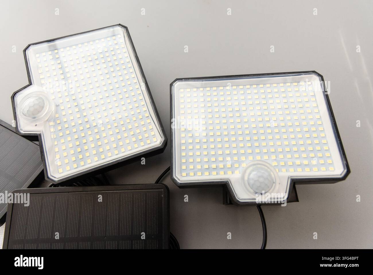 Two rectangular solar LED lights with motion sensors are displayed Stock Photo