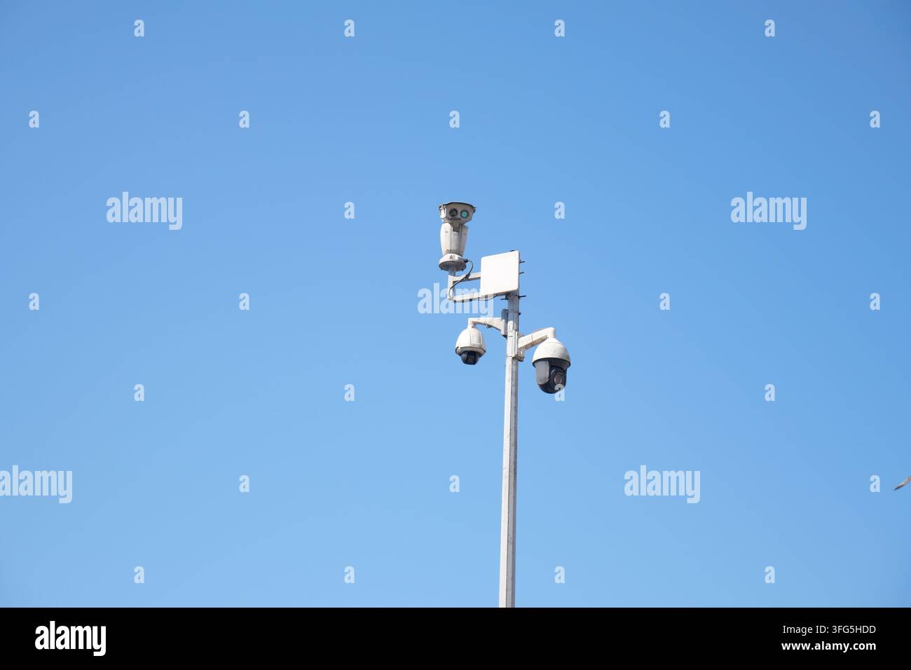 Surveillance cameras mounted on a tall pole Stock Photo