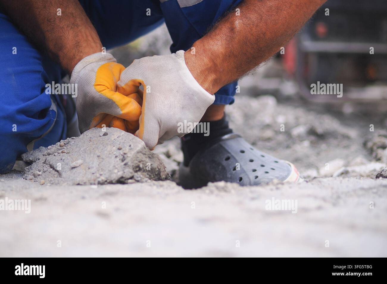Worker lays concrete in construction site Stock Photo