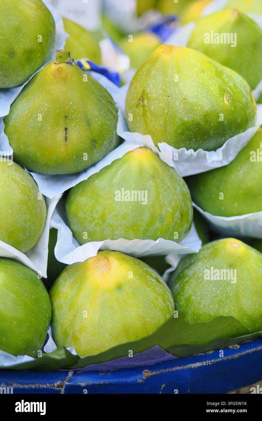 Fresh green figs in a market basket Stock Photo