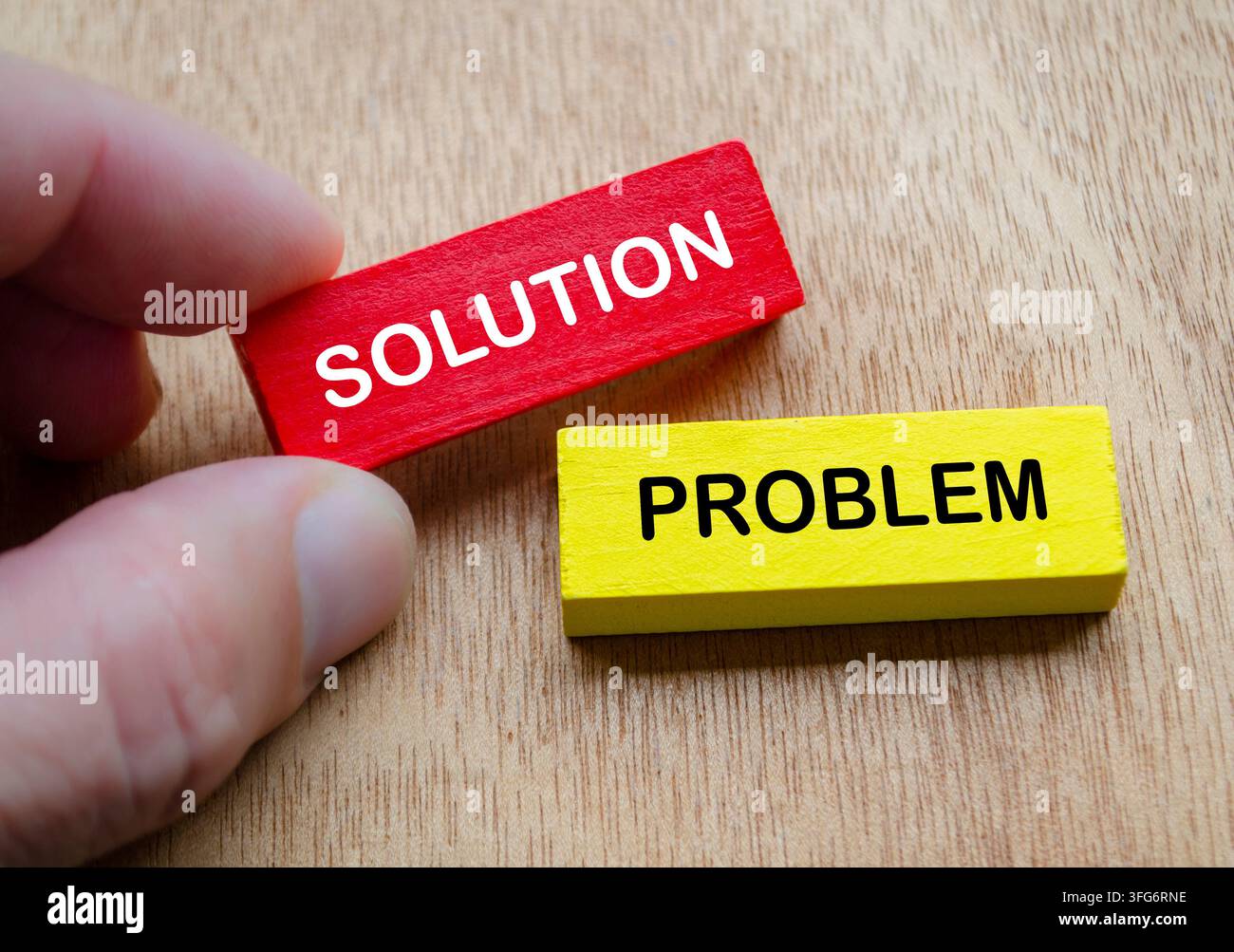 Hand holding solution and problem blocks representing effective problem solving and resolution. Stock Photo