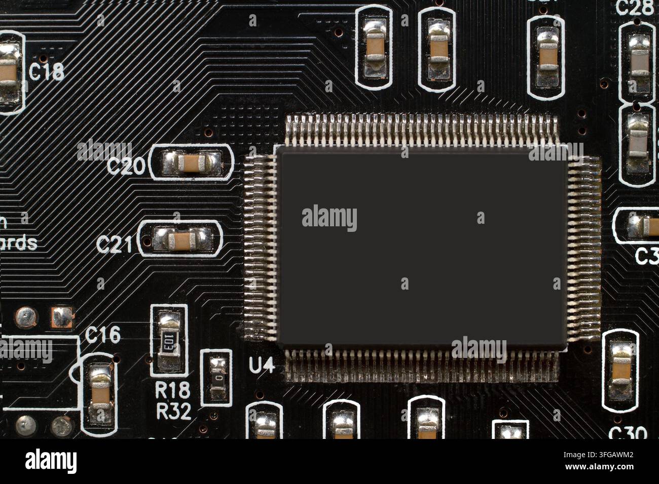 Microchip on a black printed circuit board. Electronic component with integrated circuits Stock Photo