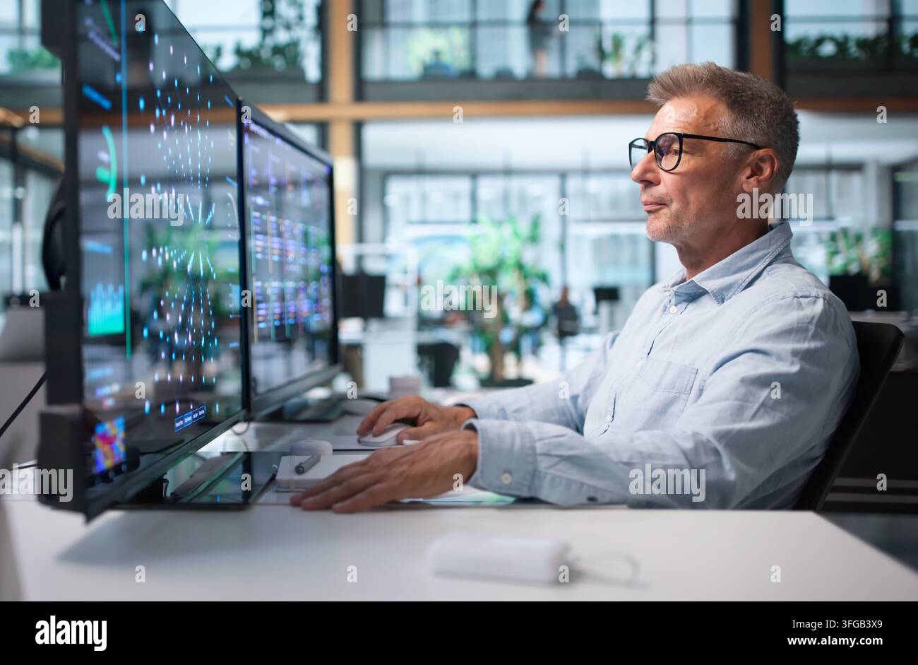 Data Scientist Analyzes Data Using Machine Learning Tools On Desktop Computer. Stock Photo