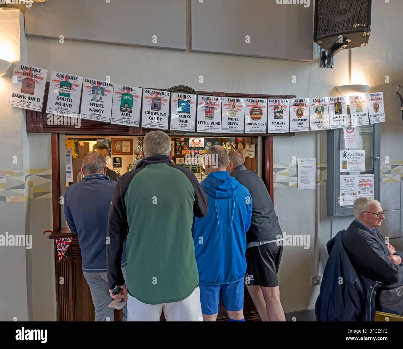 Customers ordering at a community beer festival in Appleton Thorn Village Hall, Warrington, England. Stock Photo
