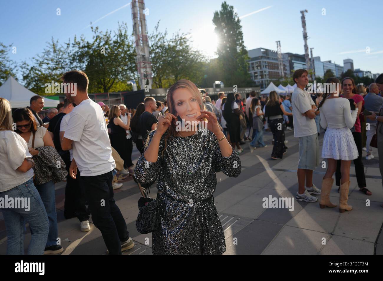 A Fan Wearing A Mask Of Singer Celine Dion Poses Before The Opening a-fan-wearing-a-mask-of-singer-celine-dion-poses-before-the-opening