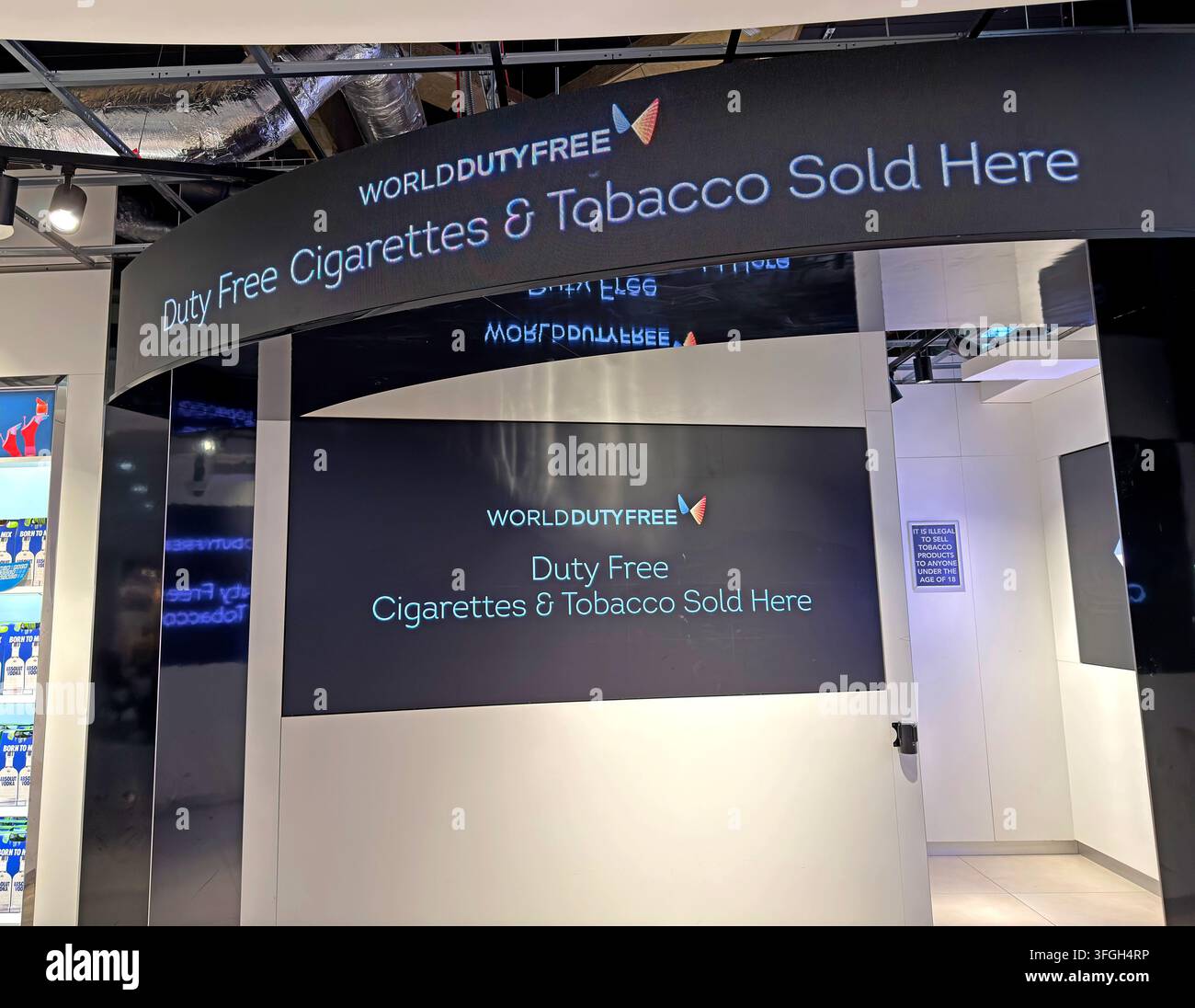 Airport duty-free tobacco shop displaying cigarettes behind screens at Manchester Airport, UK. Stock Photo