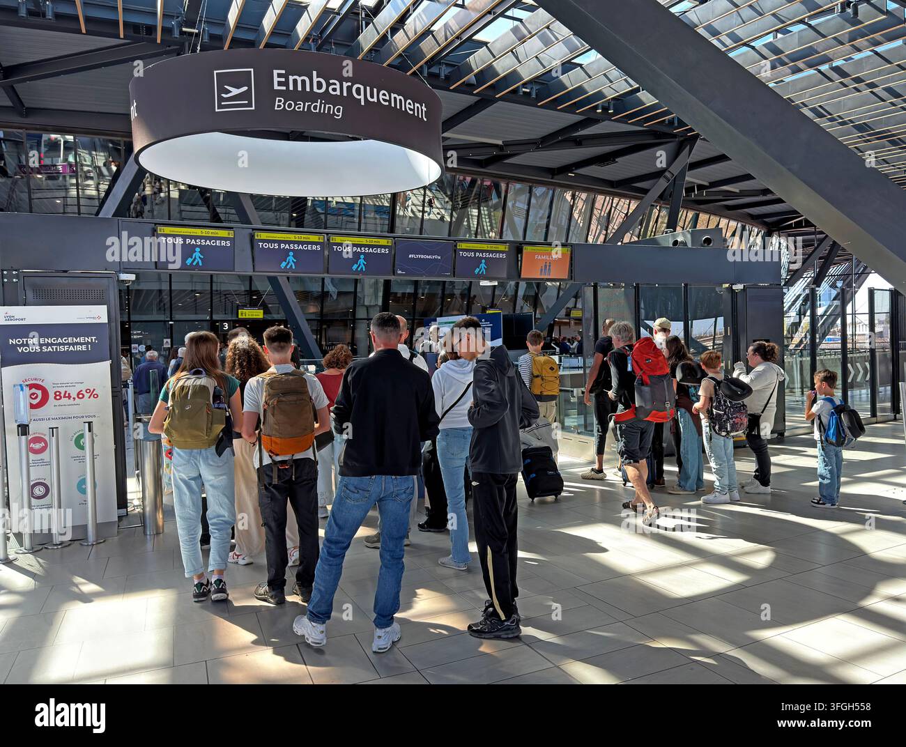 Passengers queue to enter departures at Lyon Saint-Exupéry Airport, France. Stock Photo