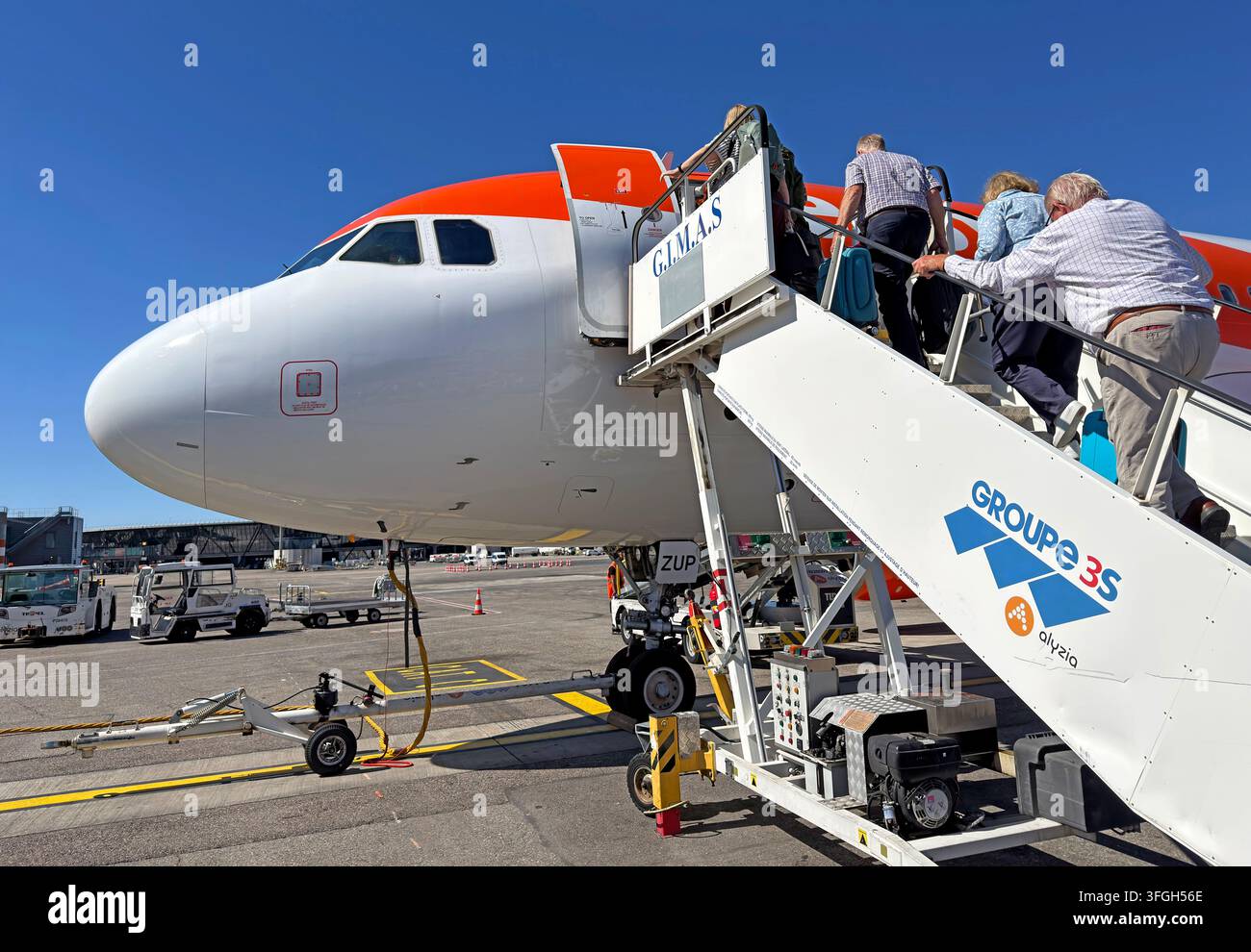 Passengers board an Airbus A320 by mobile steps at Lyon Saint-Exupéry Airport, France. Stock Photo