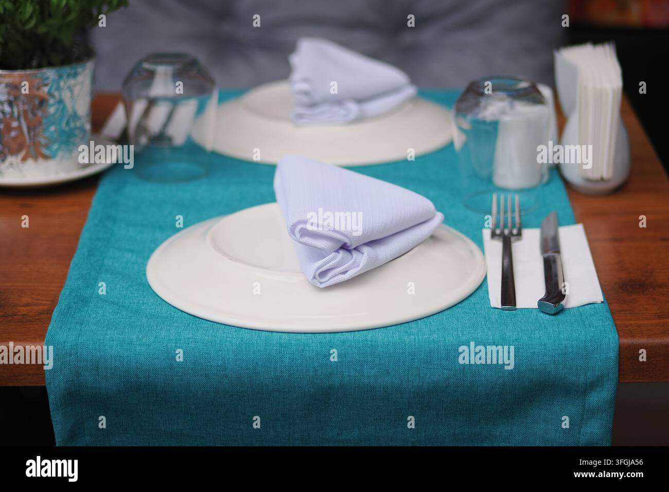 Table set with plates and utensils Stock Photo