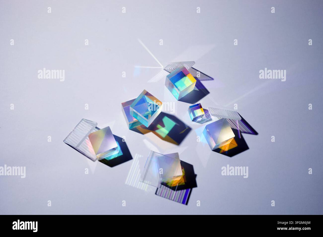 Glass prisms refracting light, creating rainbow colors Stock Photo
