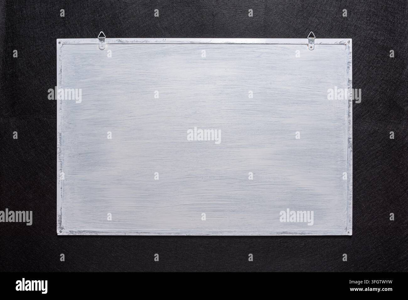 White board on black background. Surface for inscriptions Stock Photo