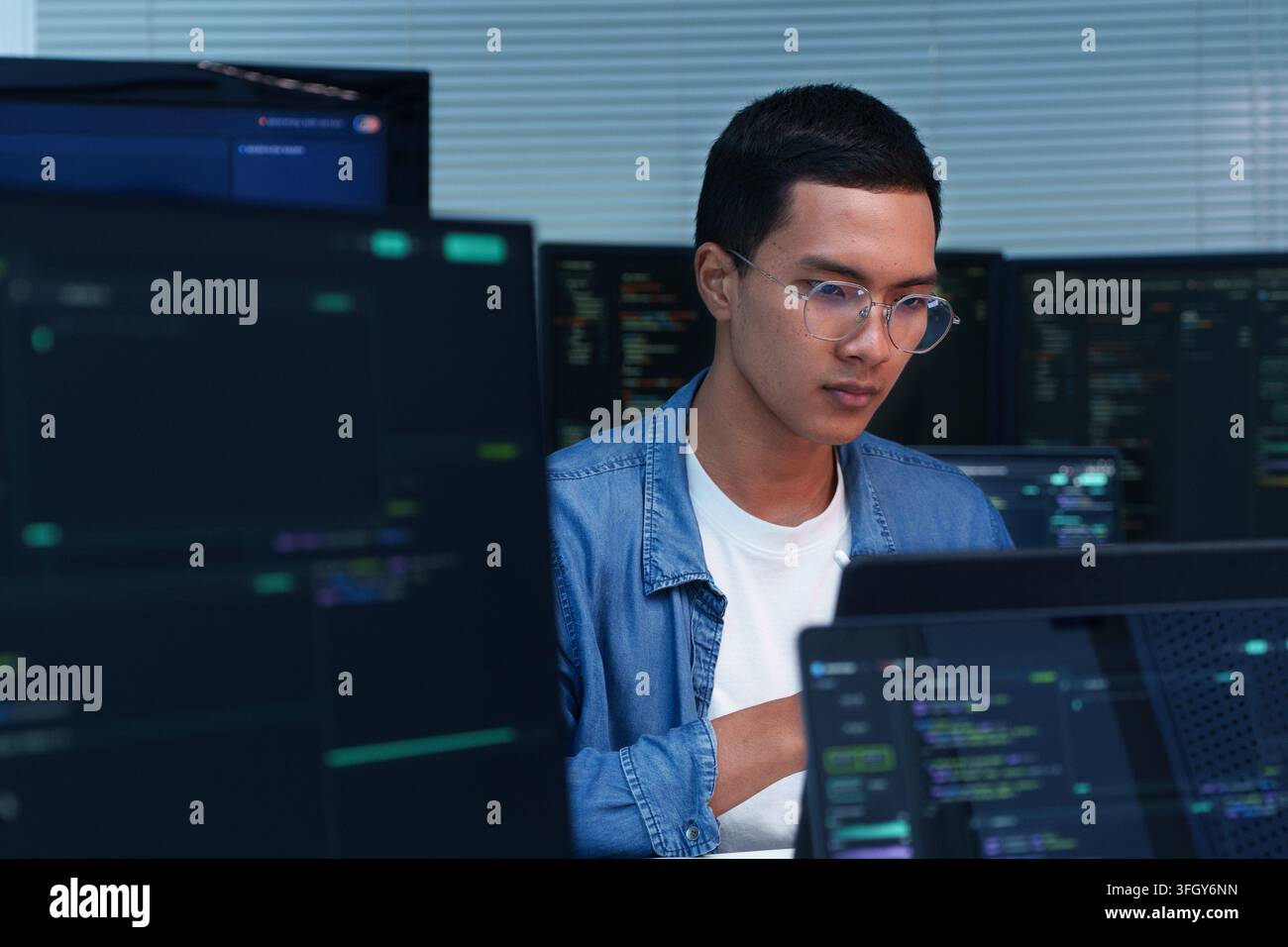 Young programmer focused on software development, coding, artificial intelligence, and digital technology projects. Stock Photo