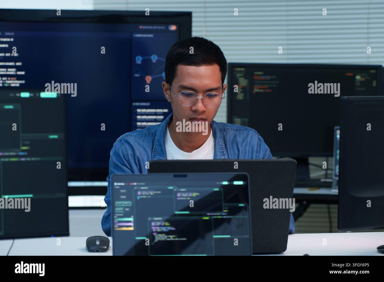 Focused programmer working on software development, writing code and exploring digital technology, cybersecurity and artificial intelligence applicati Stock Photo