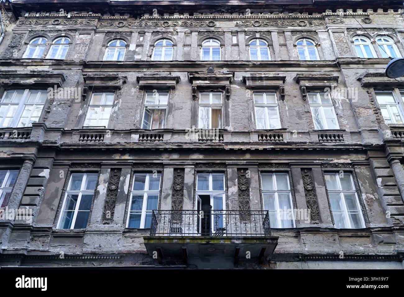 Crumbling masonry on ornately decorated old east European apartment building Stock Photo