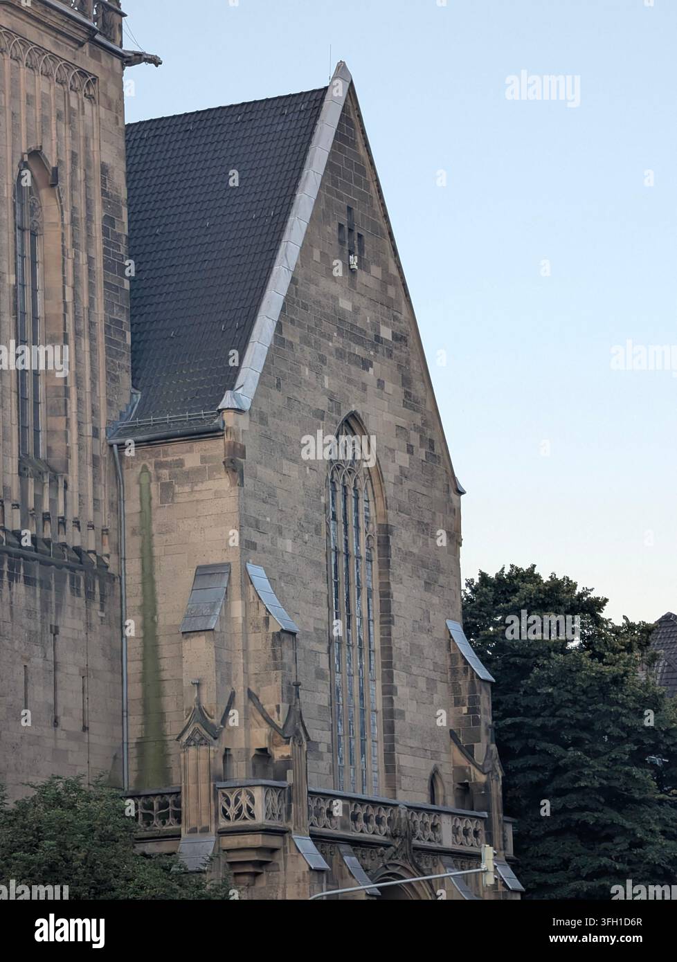 Exterior architectural views of the historic St. Elisabeth church (digitalCHURCH) featuring its tall neo-Gothic spire, bell tower - Smartphone Captured Stock Image