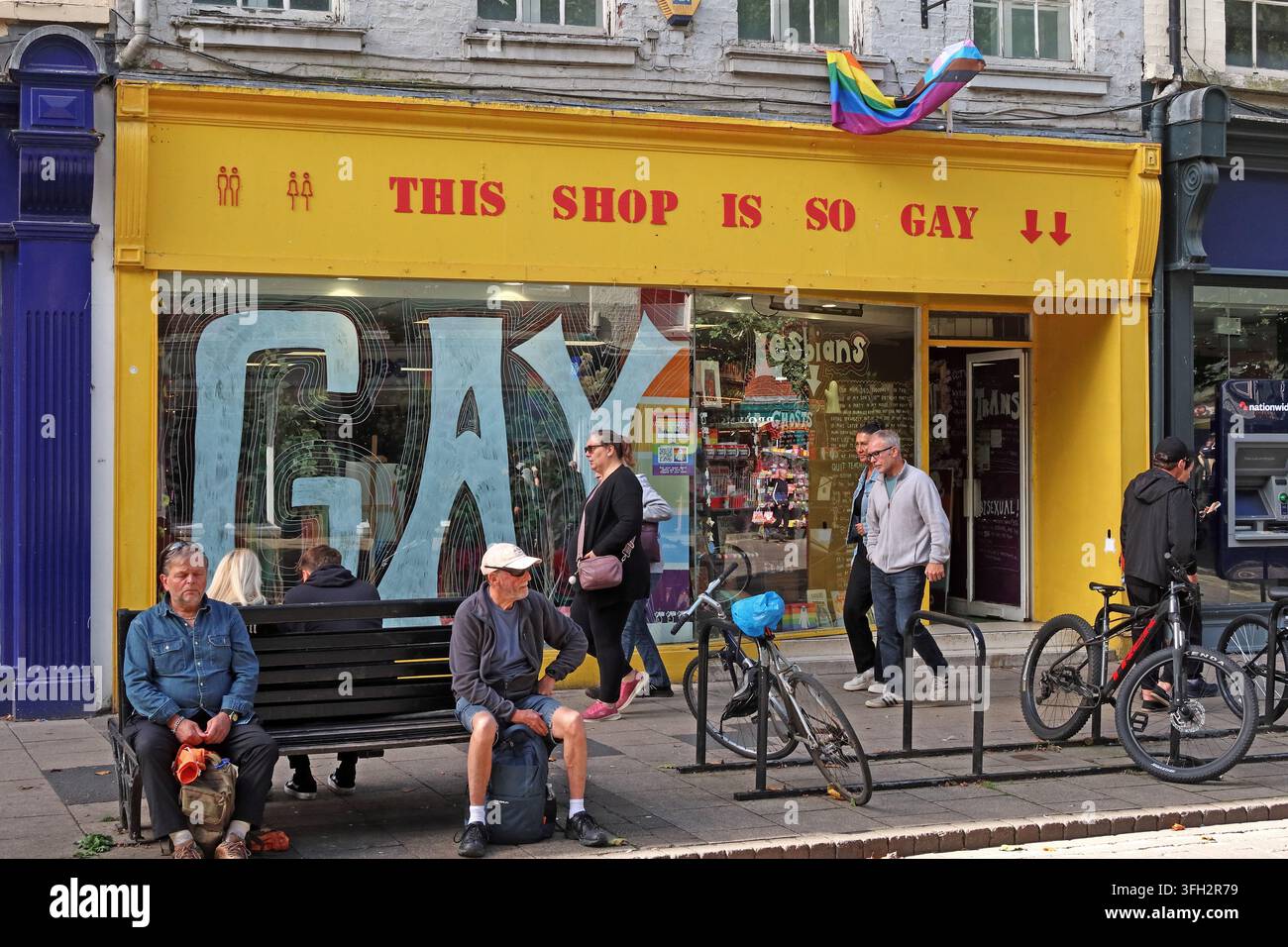 'This shop is so gay' LGBT-themed shopfront at 16 Parliament Street in York, with rainbow flags and pedestrians outside. Stock Photo
