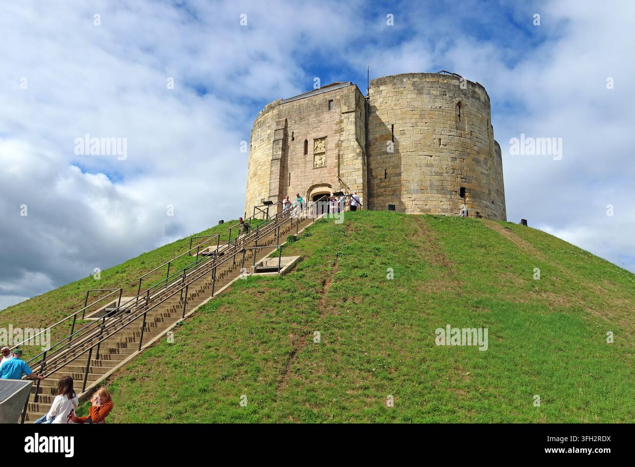 Tourists climbing Clifford's Tower in York, the medieval stone keep of York Castle standing on its steep historic motte. Stock Photo