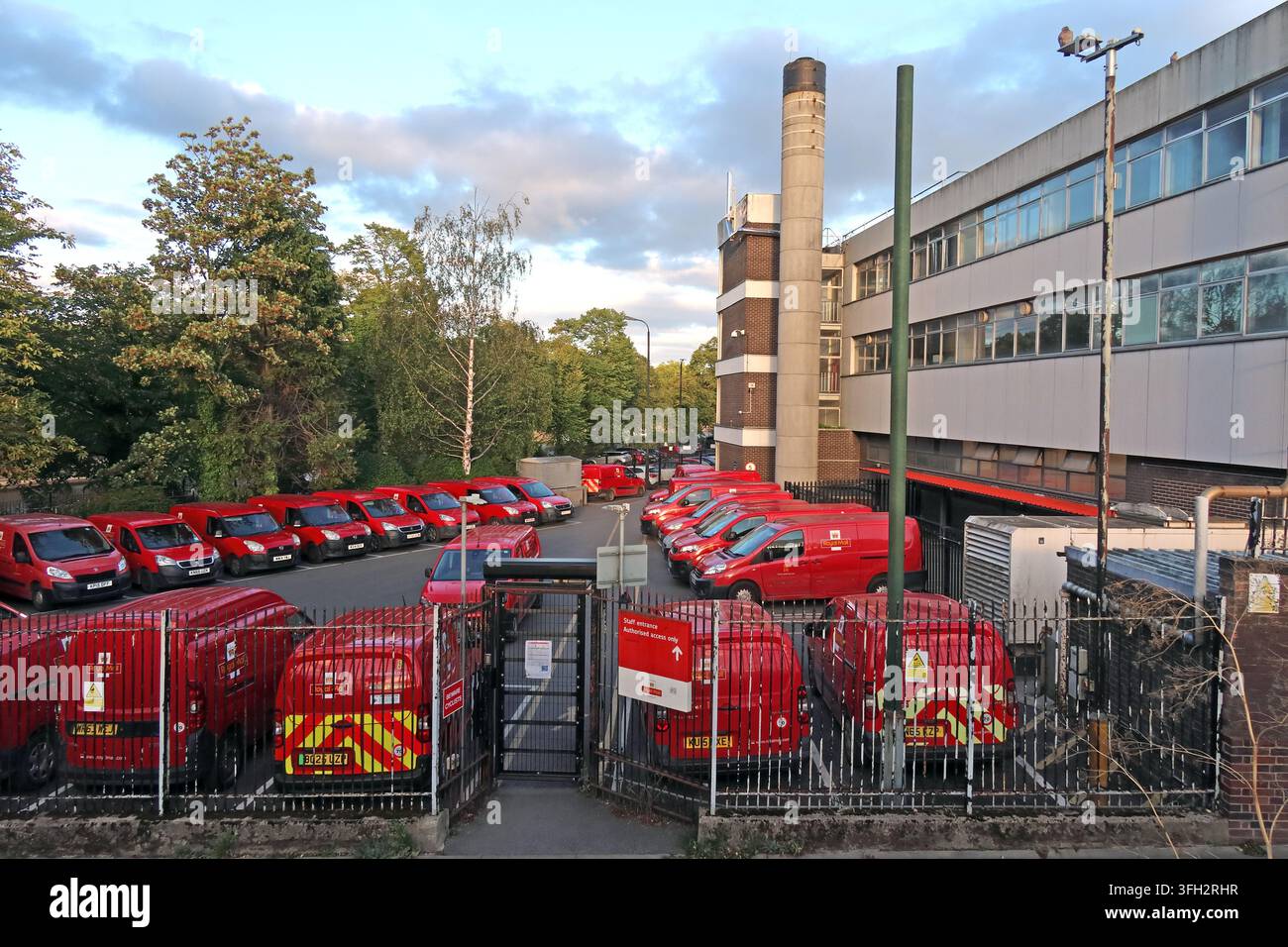 Royal Mail delivery and sorting facility in York with rows of red postal vans parked inside the operational yard as 2,500 job redundancies announced Stock Photo