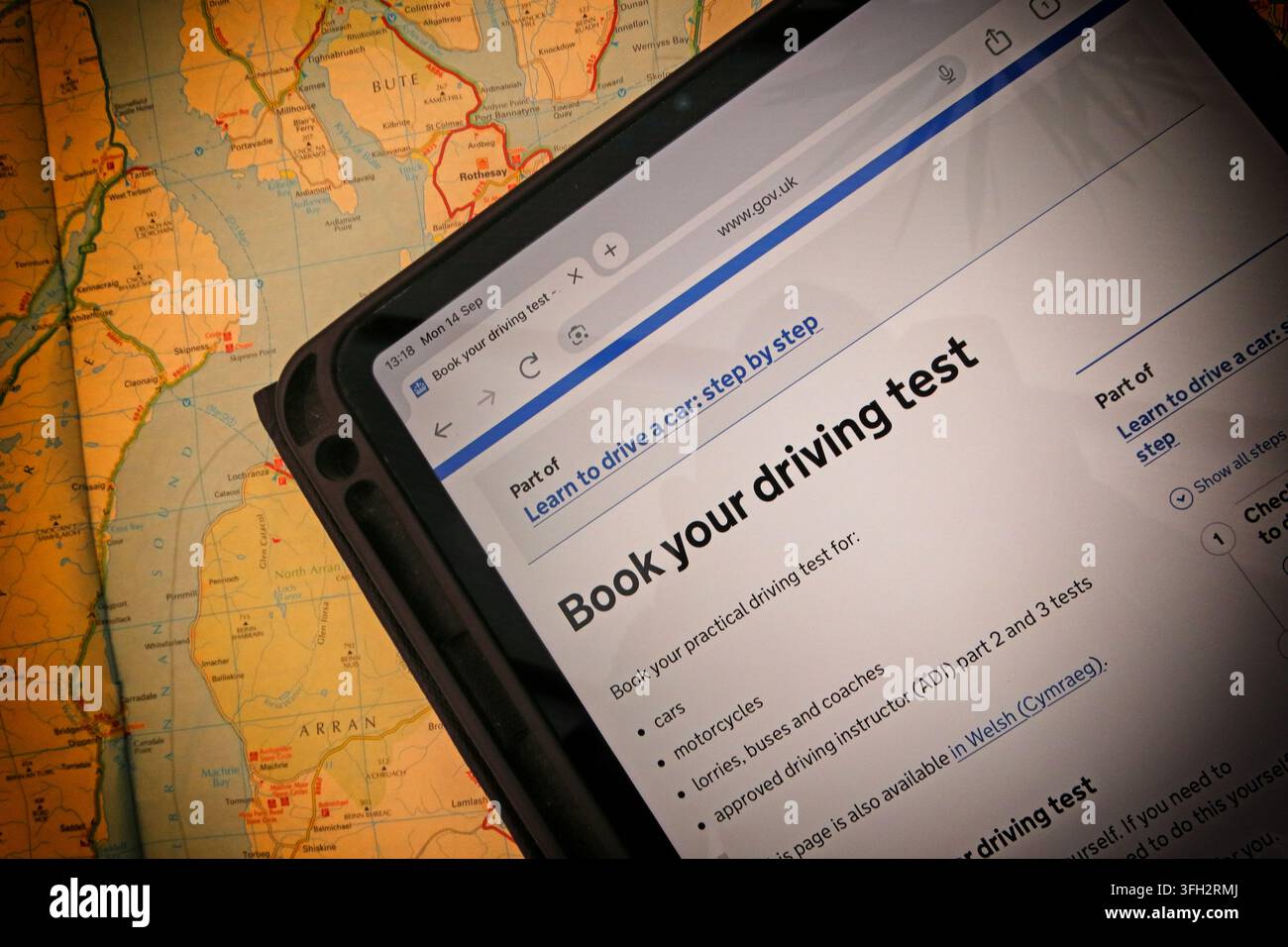 Official GOV.UK driving-test booking page displayed on a tablet in Scotland, illustrating the online process for booking a practical test. Stock Photo