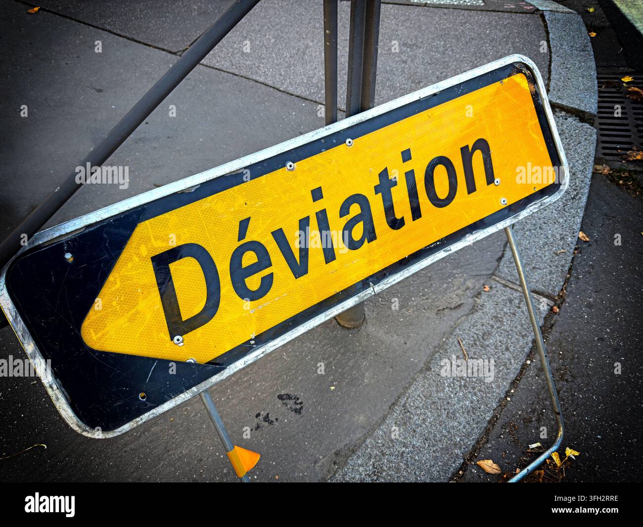 Yellow 'Déviation' temporary diversion road sign in France, used to direct traffic around a closure or roadworks. Stock Photo