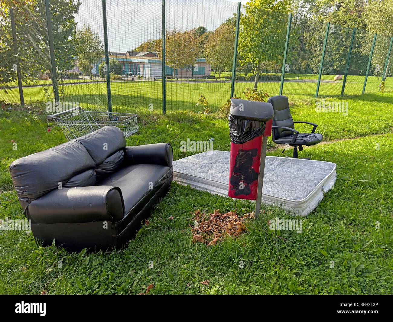 Fly-tipped sofa, chair and mattress abandoned beside a footpath on the Birch Green social housing estate in Skelmersdale. Stock Photo