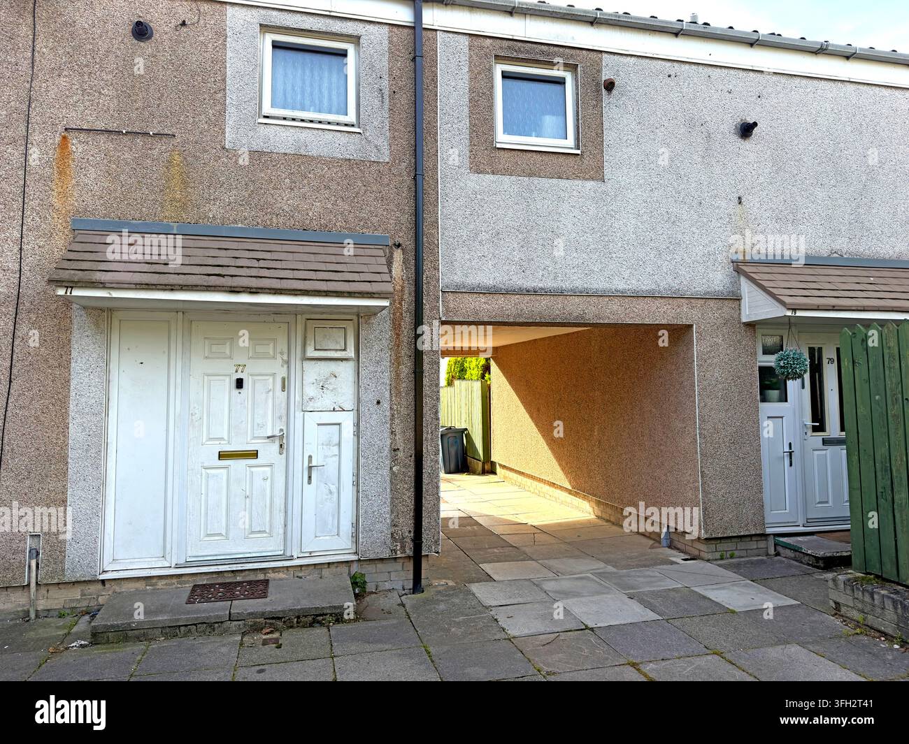 Social housing at 77-79 Fairlie in Birch Green, Skelmersdale, showing a pedestrian passage typical of planned-estate layouts, showing post-war housing Stock Photo