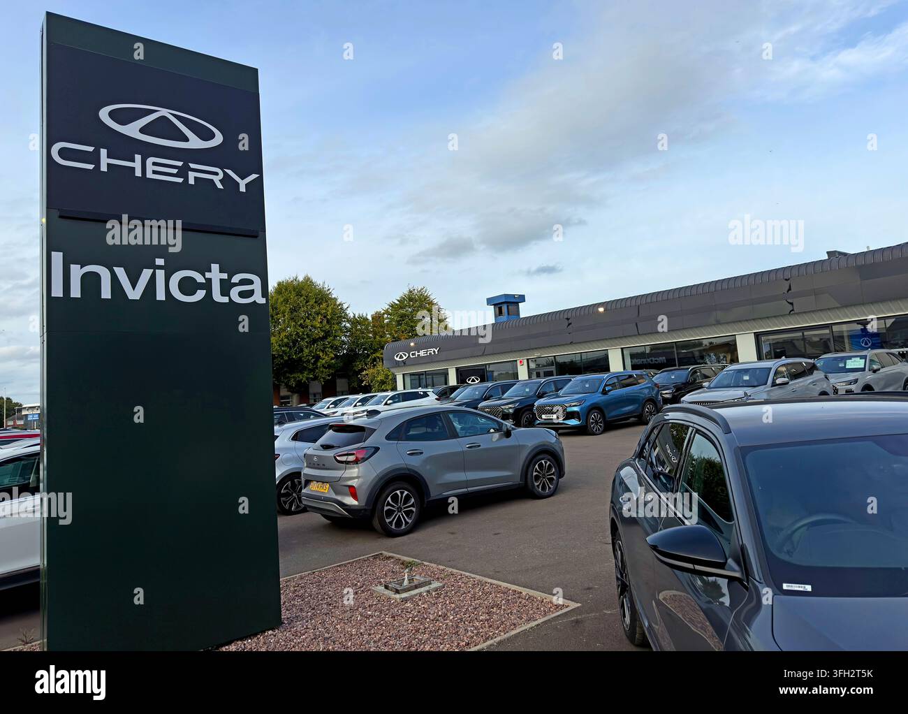 Invicta Chery dealership and roadside pylon in Warrington, showing rows of new Chinese-brand cars on the forecourt,as Chinese marques expand rapidly Stock Photo