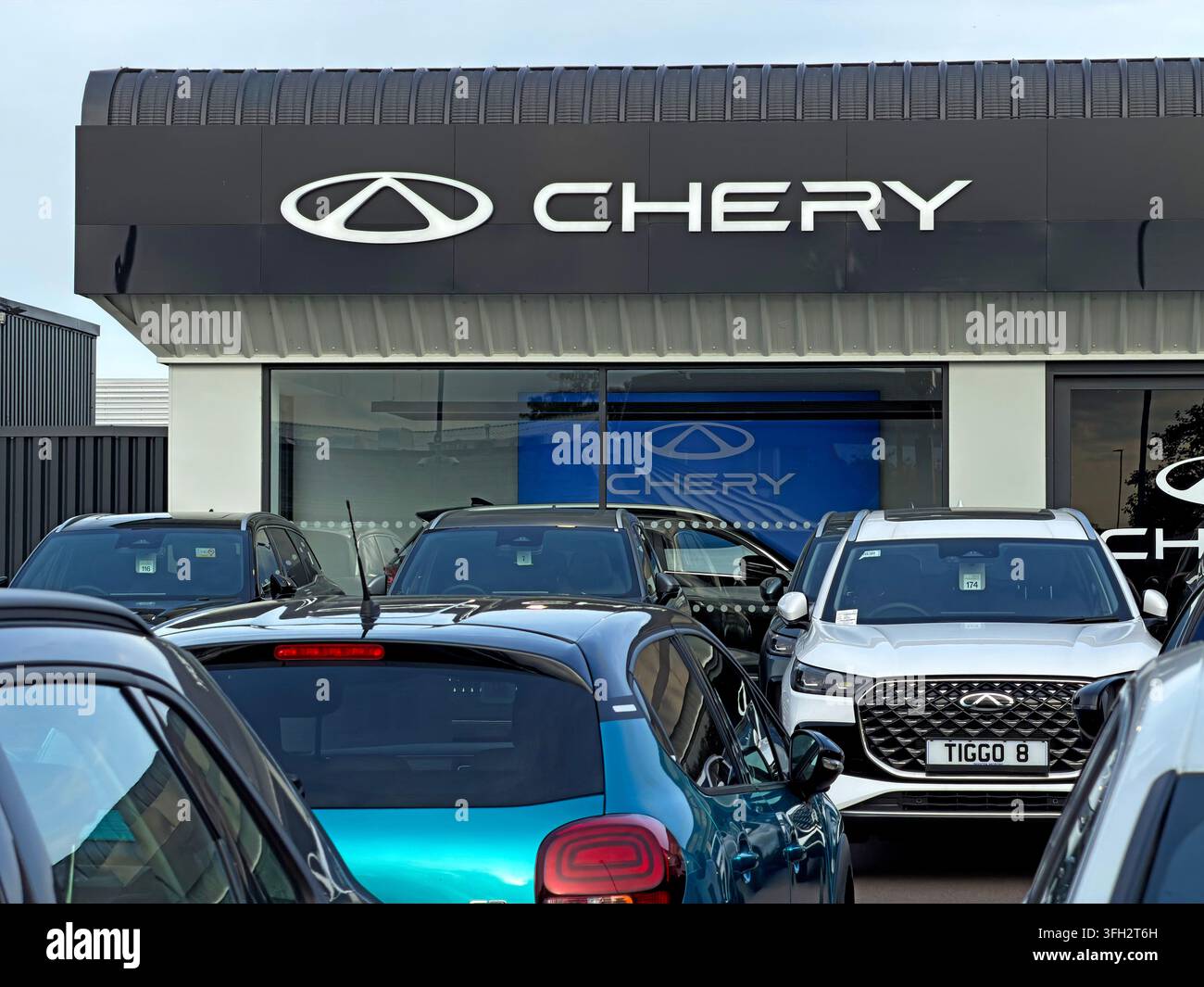 Invicta Chery dealership in Warrington with new Chery SUVs, including the Tiggo range, lined up outside the branded showroom, Chinese marque's dealer Stock Photo