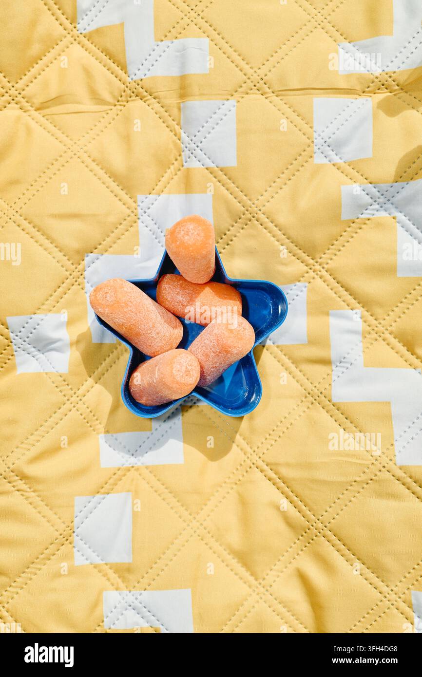 Fresh Baby Carrots in Star Shaped Bowl Prepared for Family Picnic Stock Photo