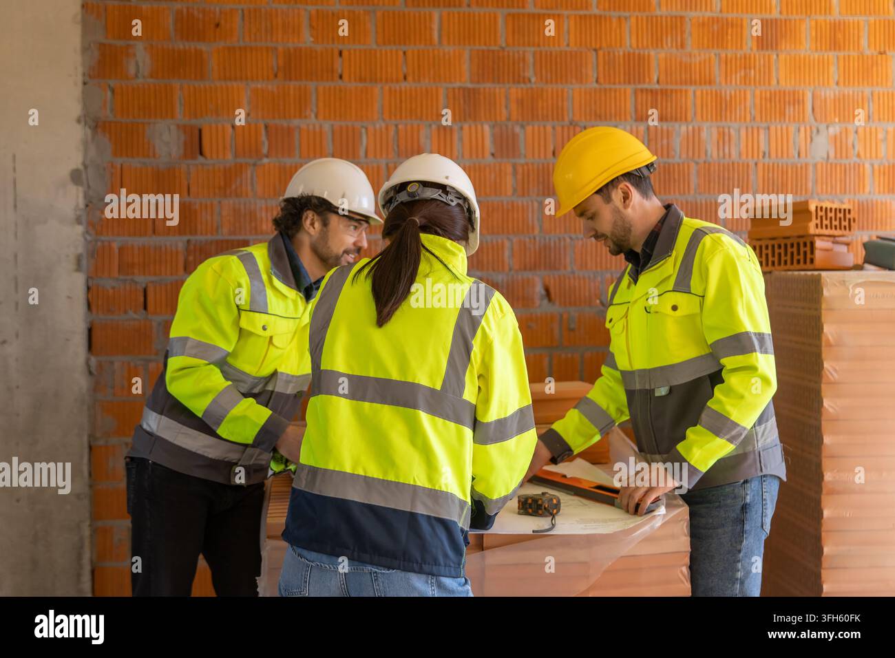 Team of architects analyzing technical blueprints Stock Photo