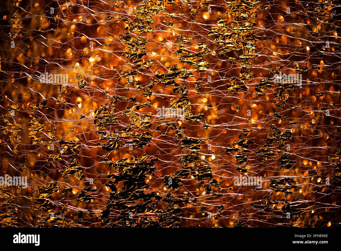 Golden nano texture in reflective gold surface. Golden shimmering backdrop for jewelry design. Golden glittering pattern on premium foil. Golden Stock Photo